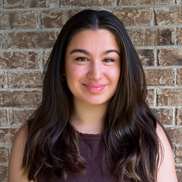 Abby Drake smiling, long dark brown hair