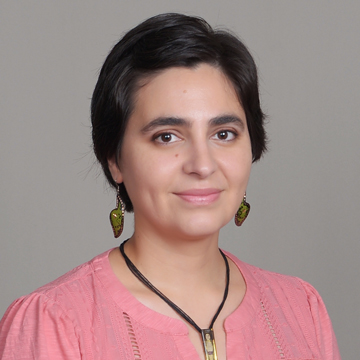 Head-and-shoulders: Rosalinda smiling at the camera, short dark hair