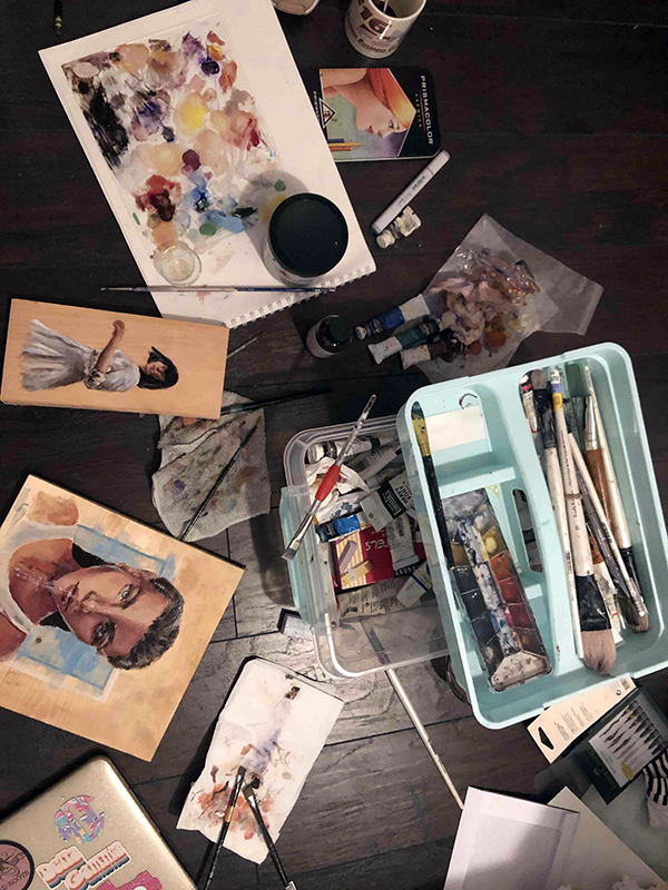 paint and a colorful painting on a table