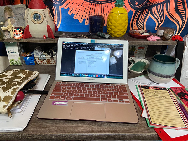 laptop on a colorfully decorated desk