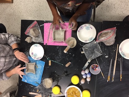 Teachers making ceramic bowls