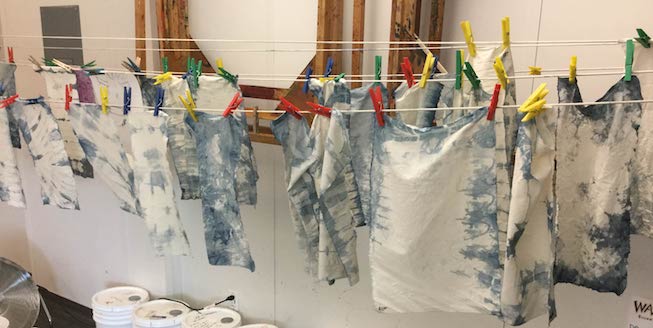 naturally dyed fabric hung on a clothes line