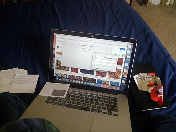 computer laptop on a bed