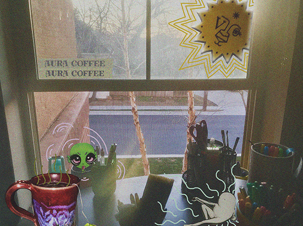View looking outside of a window from the Aura Coffee shop; cups on the table
