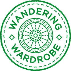 Wordmark of the Wandering Wardrobe—words inside of a wheel